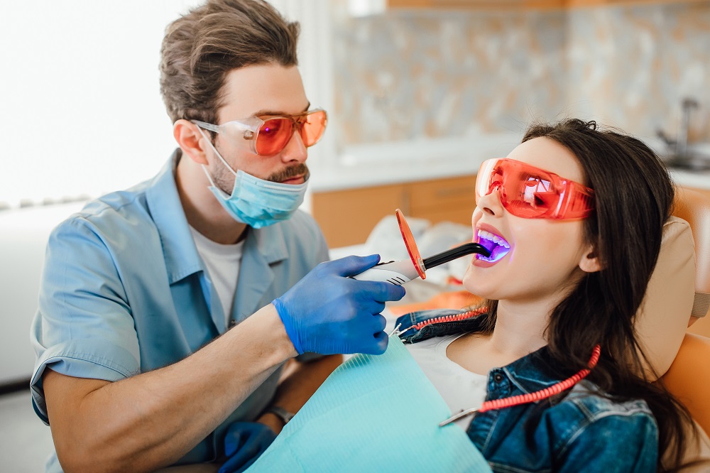 woman taking teeth whitening treatment